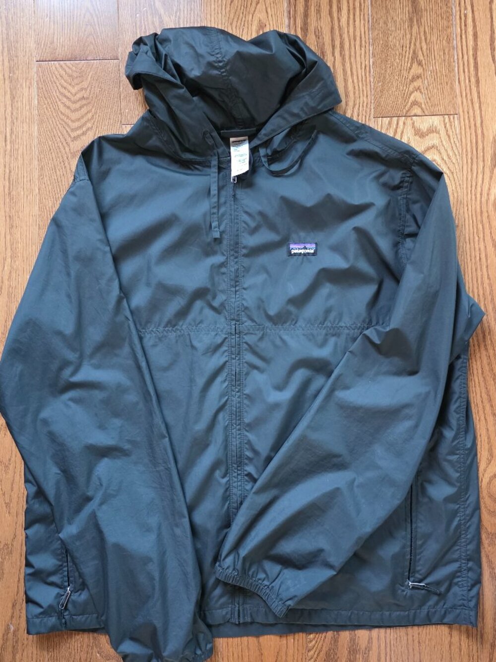 XL Patagonia lightweight black full zip hooded windbreaker with front pockets.